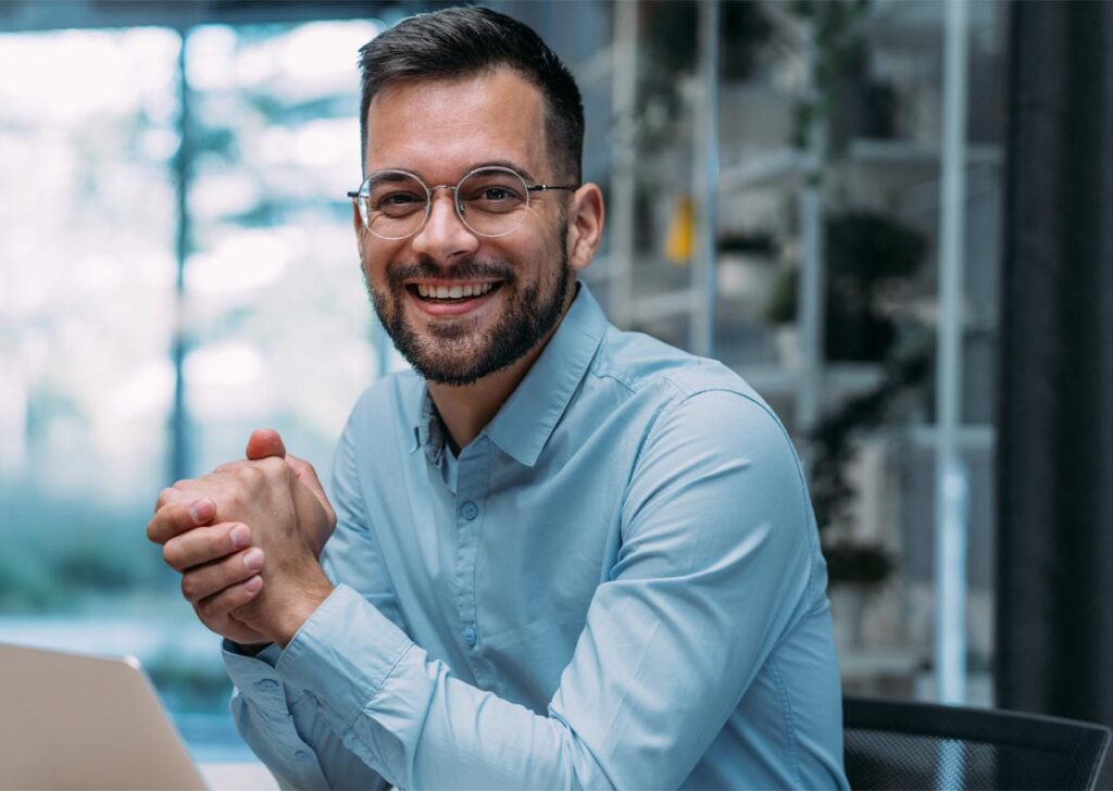 professional business man with glasses smiling into the camera